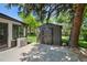 Backyard with a storage shed located near the patio and an air conditioning unit at 5265 W Quarles Dr, Littleton, CO 80128