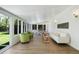 Inviting sunroom featuring laminate wood floors, ample natural light, with comfortable seating and backyard views at 5265 W Quarles Dr, Littleton, CO 80128