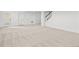 Large basement area featuring neutral carpet, white walls, and access to stairs at 8242 S Pierson St, Littleton, CO 80127