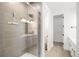 Modern bathroom featuring a glass-enclosed shower with sleek fixtures and neutral tile at 8242 S Pierson St, Littleton, CO 80127