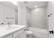 Bright bathroom featuring a combined tub and shower, vanity and a modern sink at 8242 S Pierson St, Littleton, CO 80127