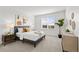 Well-lit bedroom boasts a comfortable bed, stylish furniture, and large window at 8242 S Pierson St, Littleton, CO 80127