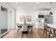 Dining room features a modern table, chairs, stainless steel appliances, and lots of natural light at 8242 S Pierson St, Littleton, CO 80127