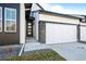 Charming exterior showcasing a modern house, a front door and a two-car garage at 8242 S Pierson St, Littleton, CO 80127