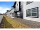 Modern townhomes showcasing sleek black and white exteriors with private balconies and green spaces at 8242 S Pierson St, Littleton, CO 80127