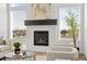 Close-up of modern fireplace with a dark mantle and three windows at 8242 S Pierson St, Littleton, CO 80127