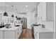 Bright kitchen with white cabinetry, quartz countertops, and stainless steel appliances at 8242 S Pierson St, Littleton, CO 80127