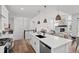 Open-concept kitchen with an island, stainless steel appliances, and modern fixtures at 8242 S Pierson St, Littleton, CO 80127