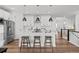 Modern kitchen with a spacious island, stainless appliances, and seating for three at 8242 S Pierson St, Littleton, CO 80127
