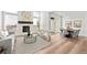 Spacious living room with fireplace flows into dining area with a patio door at 8242 S Pierson St, Littleton, CO 80127