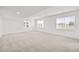 Spacious living room with plush carpet, recessed lighting, and multiple windows at 8242 S Pierson St, Littleton, CO 80127
