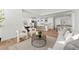 Open-concept living space with kitchen, dining area, and living room; great for entertaining at 8242 S Pierson St, Littleton, CO 80127