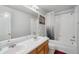 This bathroom features a double sink, tub and shower combo, and a patriotic touch with an American flag picture at 13802 Jasmine St, Thornton, CO 80602