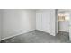 This bedroom has carpet, white walls, large closet doors, and a door to another room, offering ample space at 13802 Jasmine St, Thornton, CO 80602