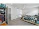 This is a bedroom with a ceiling fan, and an atached movie screen and a door leading to another room at 13802 Jasmine St, Thornton, CO 80602