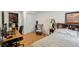 Comfortable bedroom featuring a rocking chair, closet space, and a cozy bed with a decorative headboard at 13802 Jasmine St, Thornton, CO 80602