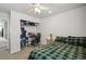 Bedroom with ceiling fan, plaid bedding, desk, chair, and storage, perfect for work and rest at 13802 Jasmine St, Thornton, CO 80602