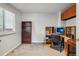 Inviting home office with ample natural light, custom shelving, and a functional workspace at 13802 Jasmine St, Thornton, CO 80602