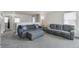 Spacious living room with plush carpeting, a comfortable seating arrangement, and neutral decor at 13802 Jasmine St, Thornton, CO 80602