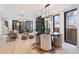 Contemporary dining space with fireplace, hardwood floors, and modern chandelier above a round table at 2961 S Cherokee, Englewood, CO 80110