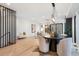 Bright dining area with hardwood floors, a modern chandelier, and seating for four at 2961 S Cherokee, Englewood, CO 80110