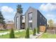 Modern two-story home featuring a gray exterior, manicured lawn, and a fenced yard at 2961 S Cherokee, Englewood, CO 80110