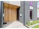 The front entrance is modern with natural wood, stylish black accents and lush landscaping at 2961 S Cherokee, Englewood, CO 80110