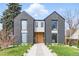 Stunning modern home featuring a gray exterior, natural wood accents, large windows, and professional landscaping at 2961 S Cherokee, Englewood, CO 80110