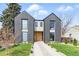 Beautiful modern house with a gray facade, an eye-catching natural wood door, and manicured landscaping at 2961 S Cherokee, Englewood, CO 80110
