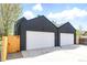 Two-car garage with white doors, black trim, and access from the backyard at 2961 S Cherokee, Englewood, CO 80110