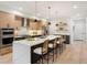 Bright kitchen features an island with bar seating, stainless appliances, and lots of storage at 2961 S Cherokee, Englewood, CO 80110