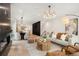 Spacious living area with hardwood floors, stylish furniture, and an open layout to the dining area at 2961 S Cherokee, Englewood, CO 80110