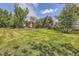 Sprawling backyard with beautiful landscaping and mature trees create a peaceful oasis at 12196 W Belleview Dr, Littleton, CO 80127