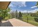Enjoy gorgeous mountain views from this deck with black iron railing and wood flooring at 12196 W Belleview Dr, Littleton, CO 80127
