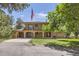 Charming two-story home with brick facade, balcony, spacious driveway, and attached two-car garage at 12196 W Belleview Dr, Littleton, CO 80127