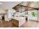 Modern kitchen boasts a center island, stainless steel appliances, and wood plank ceiling at 12196 W Belleview Dr, Littleton, CO 80127