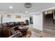 Basement living room with a large brown leather sofa and staircase at 3679 Ivanhoe St, Denver, CO 80207