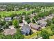 Stunning aerial view of the home, situated on a lush golf course, surrounded by mature trees and beautiful landscaping at 2247 Eagles Nest Dr, Lafayette, CO 80026