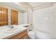 Bathroom with tub and shower combination, neutral tile, and ample vanity space at 2247 Eagles Nest Dr, Lafayette, CO 80026