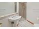 Bathroom featuring a glass-enclosed shower and pedestal sink at 2247 Eagles Nest Dr, Lafayette, CO 80026