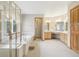 Bright bathroom featuring a glass-enclosed shower, soaking tub, and a vanity with ample counter space at 2247 Eagles Nest Dr, Lafayette, CO 80026