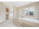 Bright bathroom featuring a glass-enclosed shower, soaking tub, and a neutral color scheme at 2247 Eagles Nest Dr, Lafayette, CO 80026