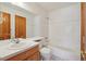 Traditional bathroom features a standard tub and shower, a mirror, and sink with wooden cabinets at 2247 Eagles Nest Dr, Lafayette, CO 80026