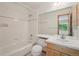 Bathroom includes a tub and shower, a mirror, and a vanity sink with wooden cabinets for storage at 2247 Eagles Nest Dr, Lafayette, CO 80026