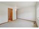 Bedroom boasts natural light, neutral walls and carpet, with easy access to a bathroom and a closet at 2247 Eagles Nest Dr, Lafayette, CO 80026