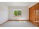 Light-filled bedroom with a window overlooking the trees and a closet for convenient storage at 2247 Eagles Nest Dr, Lafayette, CO 80026