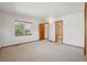 Open bedroom leads to the bathroom and offers lots of natural light through a large window at 2247 Eagles Nest Dr, Lafayette, CO 80026