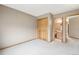Bedroom with neutral tones, bi-fold closet doors, carpet flooring and an adjoining bathroom at 2247 Eagles Nest Dr, Lafayette, CO 80026