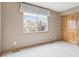 Bright bedroom features a window with exterior view and a closet with paneled doors at 2247 Eagles Nest Dr, Lafayette, CO 80026