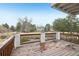 Deck with wooden railing overlooking lush green landscaping and nearby home at 2247 Eagles Nest Dr, Lafayette, CO 80026